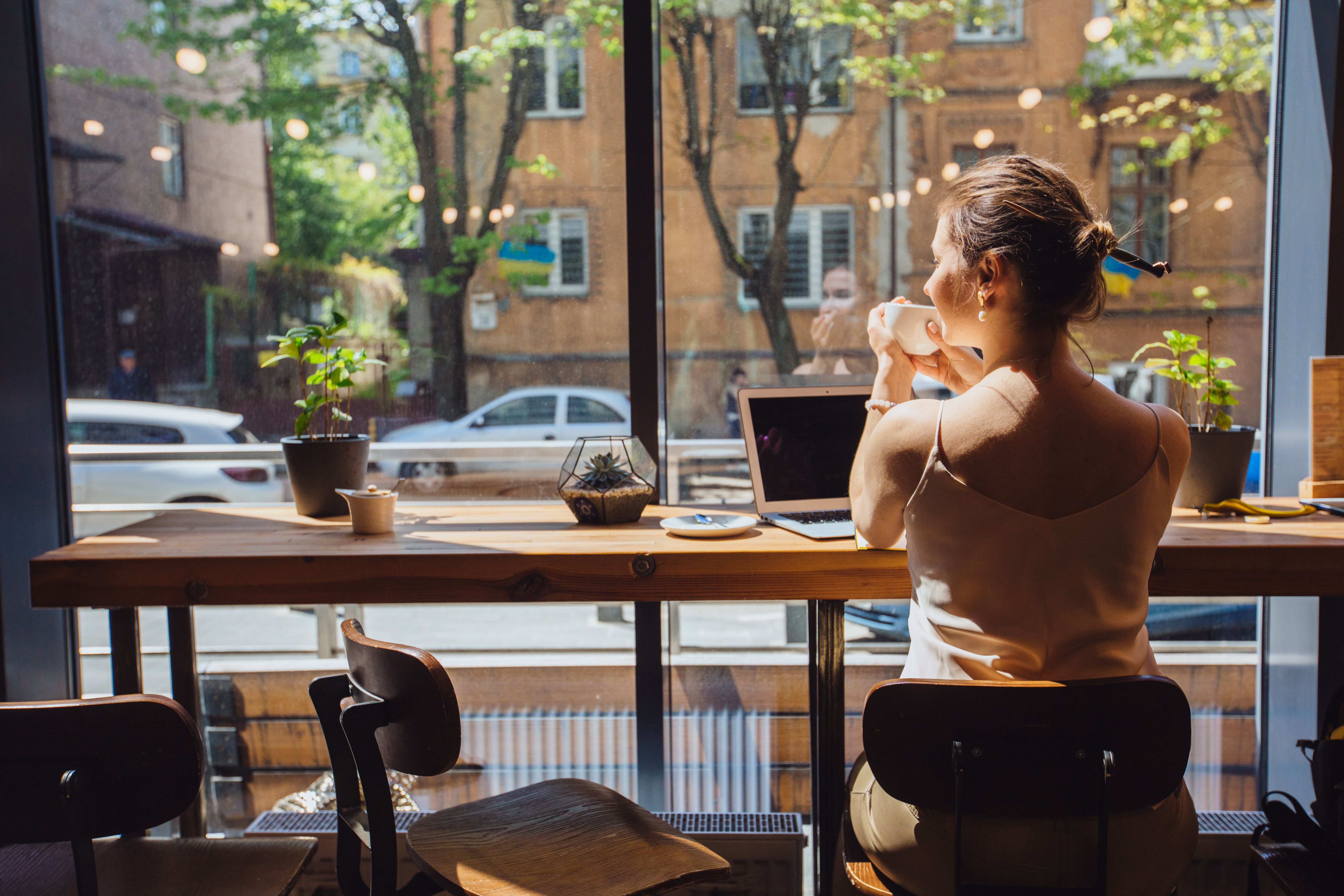 woman working on her laptop in a coffee shop